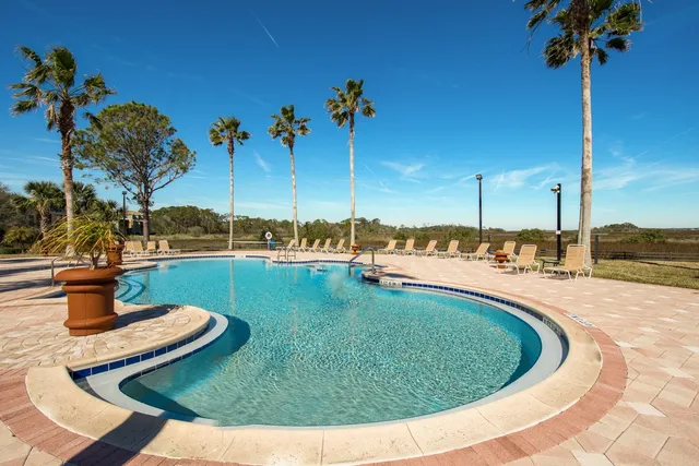 a view of a swimming pool with a yard