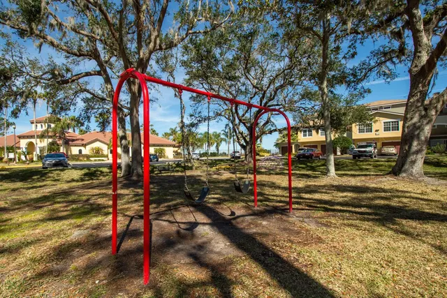 a street sign on a sidewalk next to a road