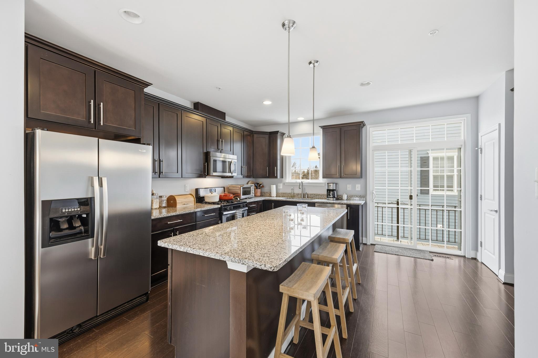 31 Meridian Lane Towson, MD 21286 - Photo 13 of 25 a kitchen with stainless steel appliances granite countertop a refrigerator a sink dishwasher a stove and a refrigerator with wooden floor