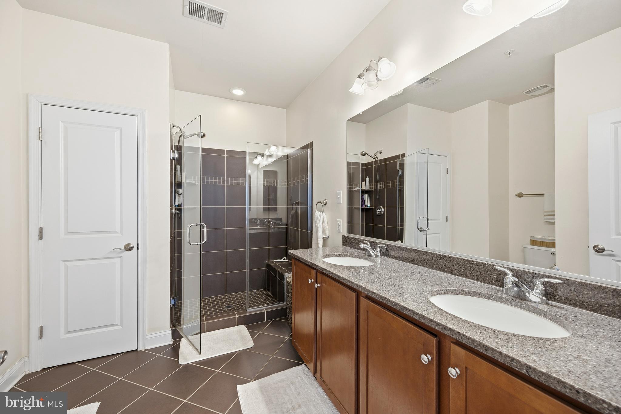 31 Meridian Lane Towson, MD 21286 - Photo 18 of 25 a bathroom with a granite countertop shower sink and mirror