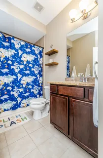a bathroom with a sink toilet and shower
