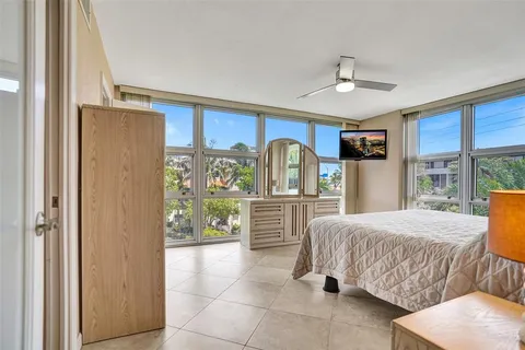 a bedroom with a bed and glass wall