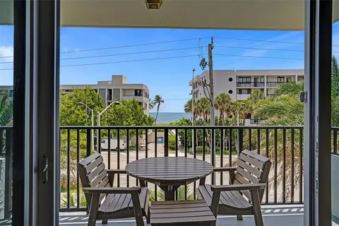 a view of a balcony with chairs