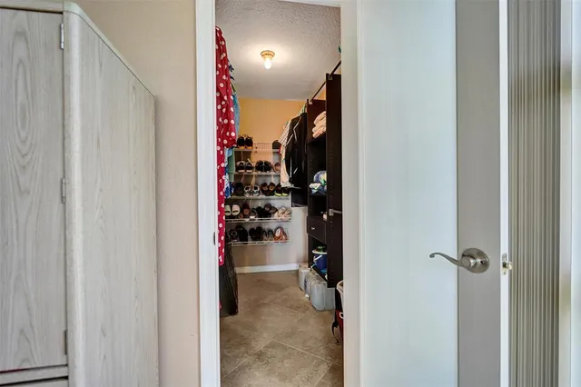 a bedroom with a bed mirror and window