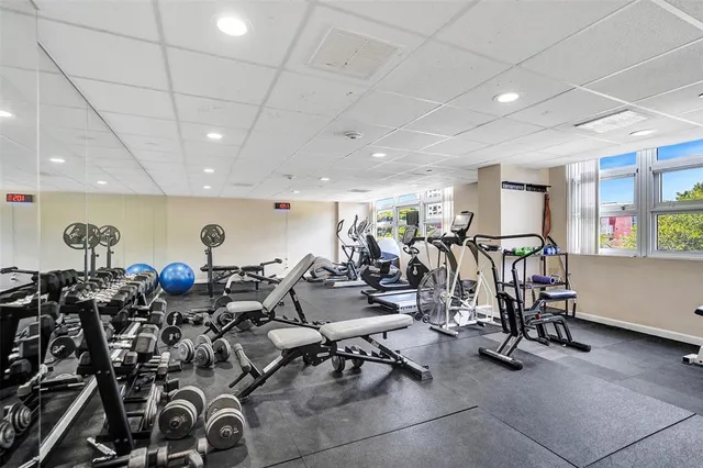 a view of a livingroom with workspace and a bookshelf