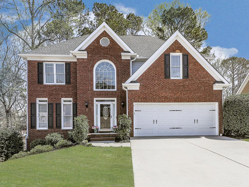 7046 Hunters Ridge Woodstock, GA 30189 - Photo 1 of 1 front view of a house with a yard