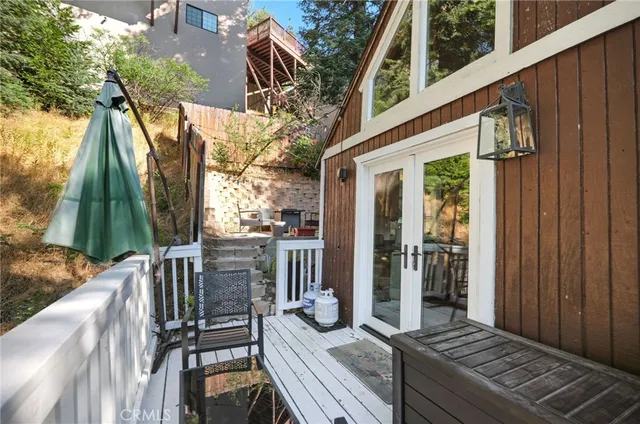 a view of balcony with wooden floor and fence