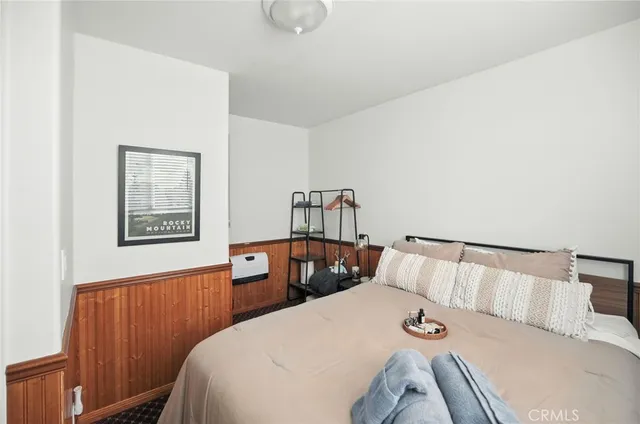 a bedroom with a bed and window