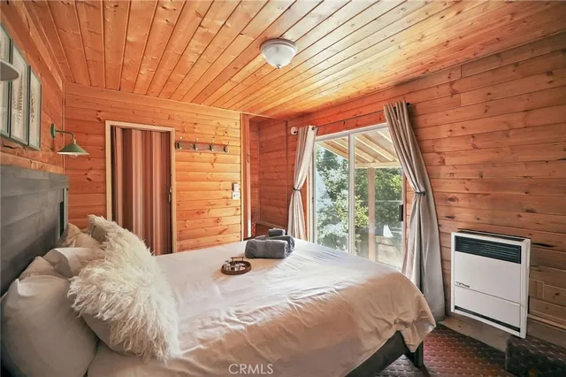 a bedroom with a bed and a large window