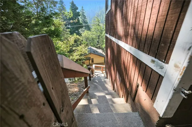 a view of balcony with wooden floor and fence