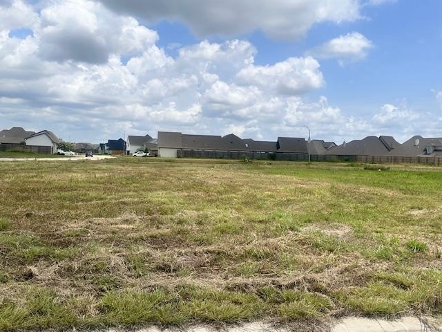 3635 Trenton Lane Beaumont, TX 77713 - Photo 1 of 6 a view of a lake with houses in the background
