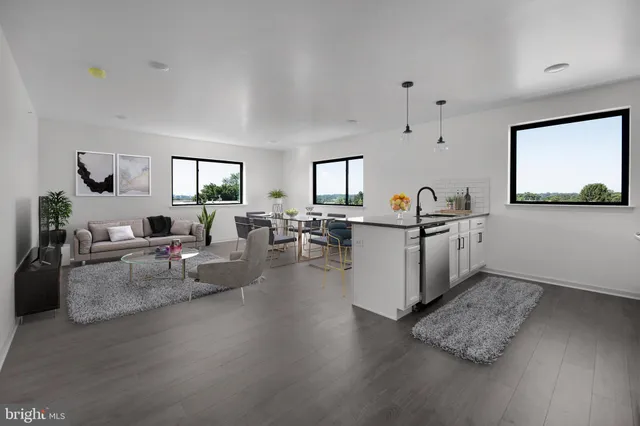a living room with furniture and view of kitchen