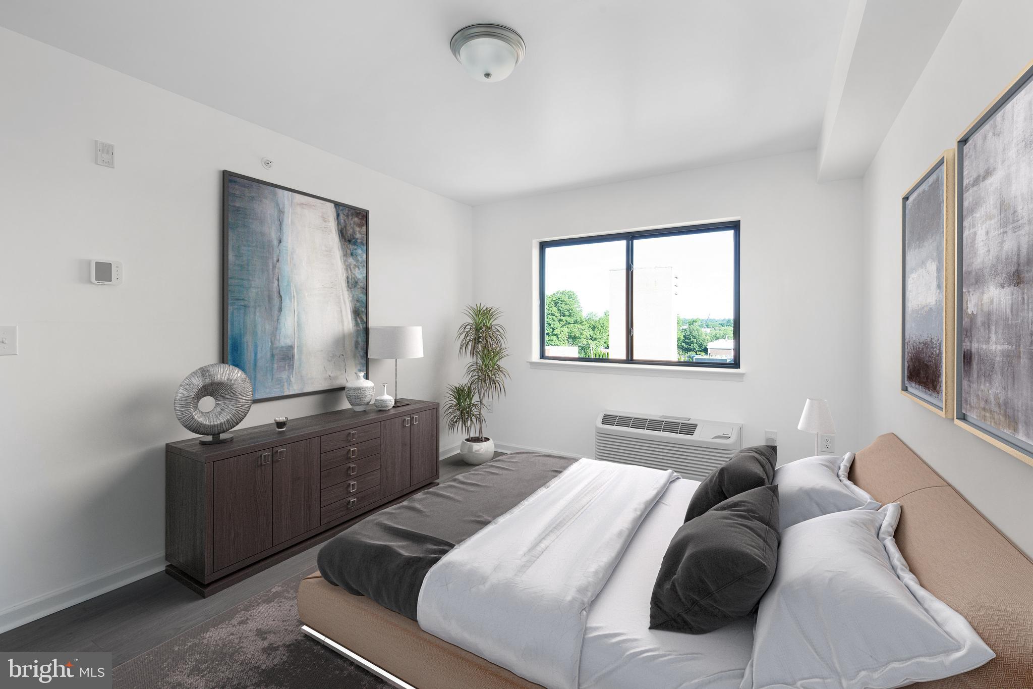 6618 Ridge Avenue, Unit 504 Philadelphia, PA 19128 - Photo 2 of 6 a bedroom with a bed and window
