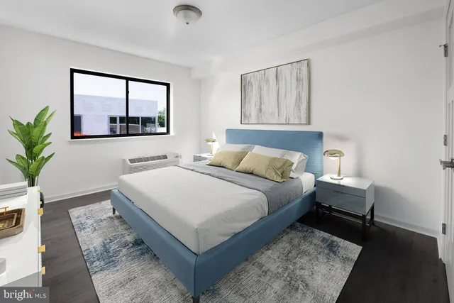 a bedroom with a large bed and a window