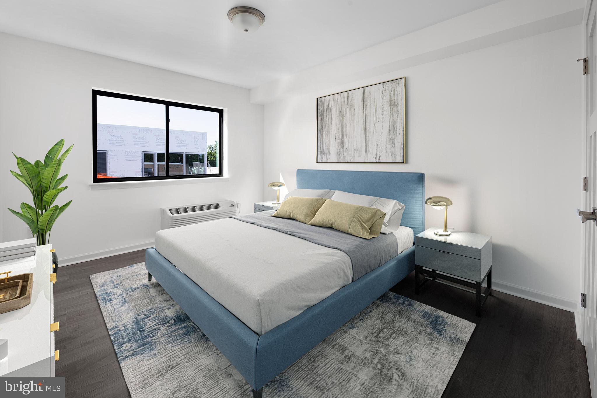 6618 Ridge Avenue, Unit 504 Philadelphia, PA 19128 - Photo 3 of 6 a bedroom with a large bed and a window