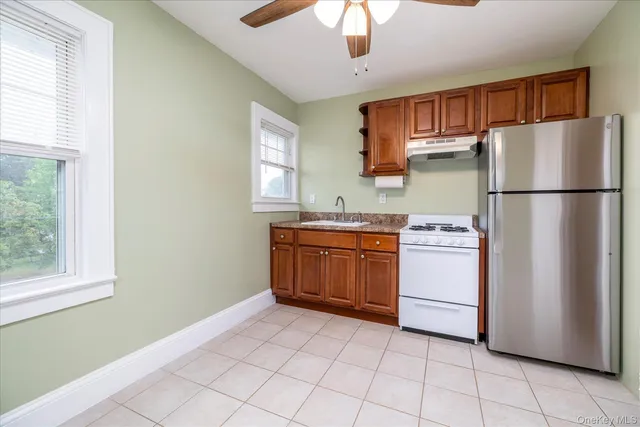 a kitchen with a refrigerator and a stove top oven