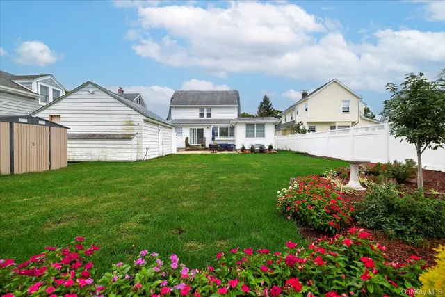 a view of a house with a big yard and potted plants
