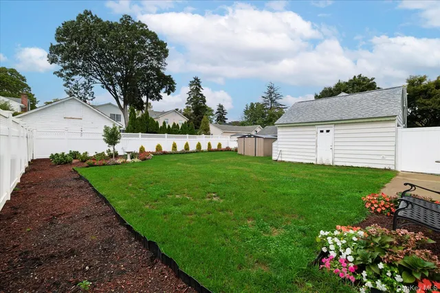 a view of a garden with flowers and trees