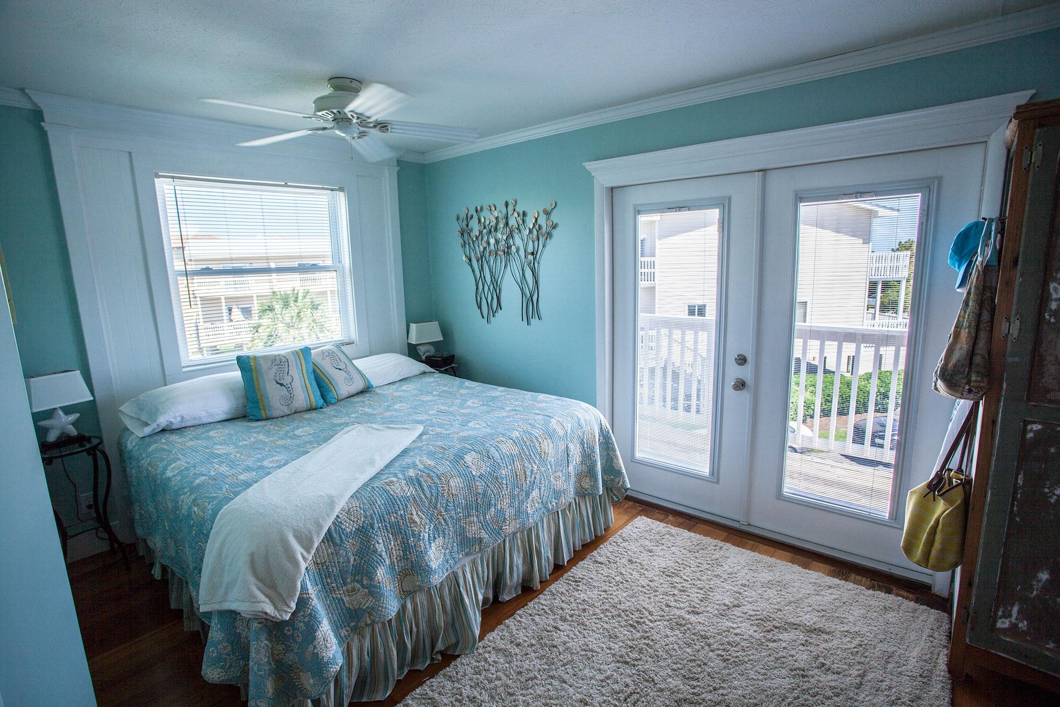 191 Blue Mountain Road, Unit 201 Santa Rosa Beach, FL 32459 - Photo 8 of 16 a bedroom with a bed and a chandelier