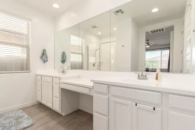 a bathroom with a sink double vanity and a mirror