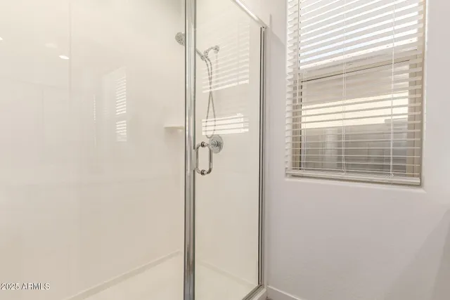 a bathroom with a glass shower door