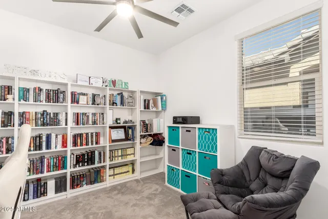 a living room with furniture and a book shelf