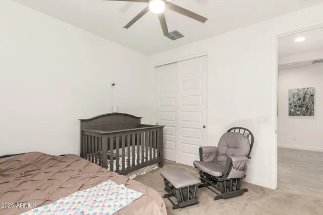 a bedroom with a bed and chair