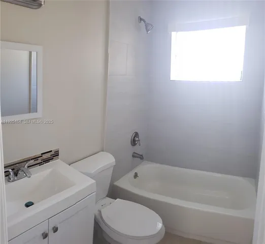 a bathroom with a toilet sink and bathtub