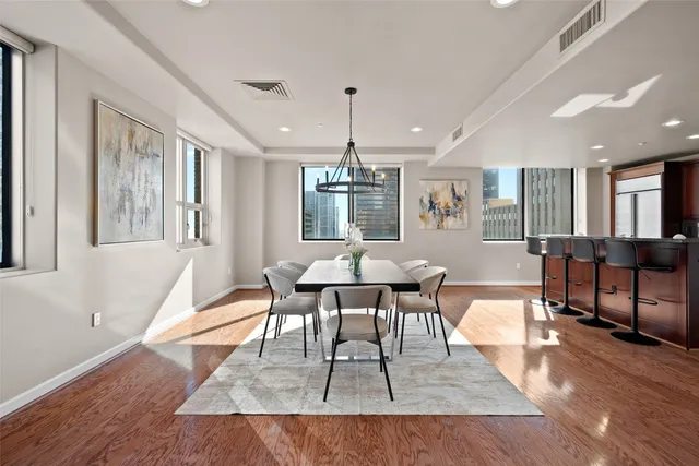 a view of a dining room with furniture window and wooden floor