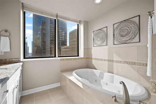 a bathroom with a bathtub and a window