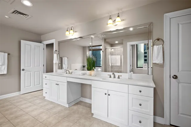 a bathroom with a sink vanity and a mirror