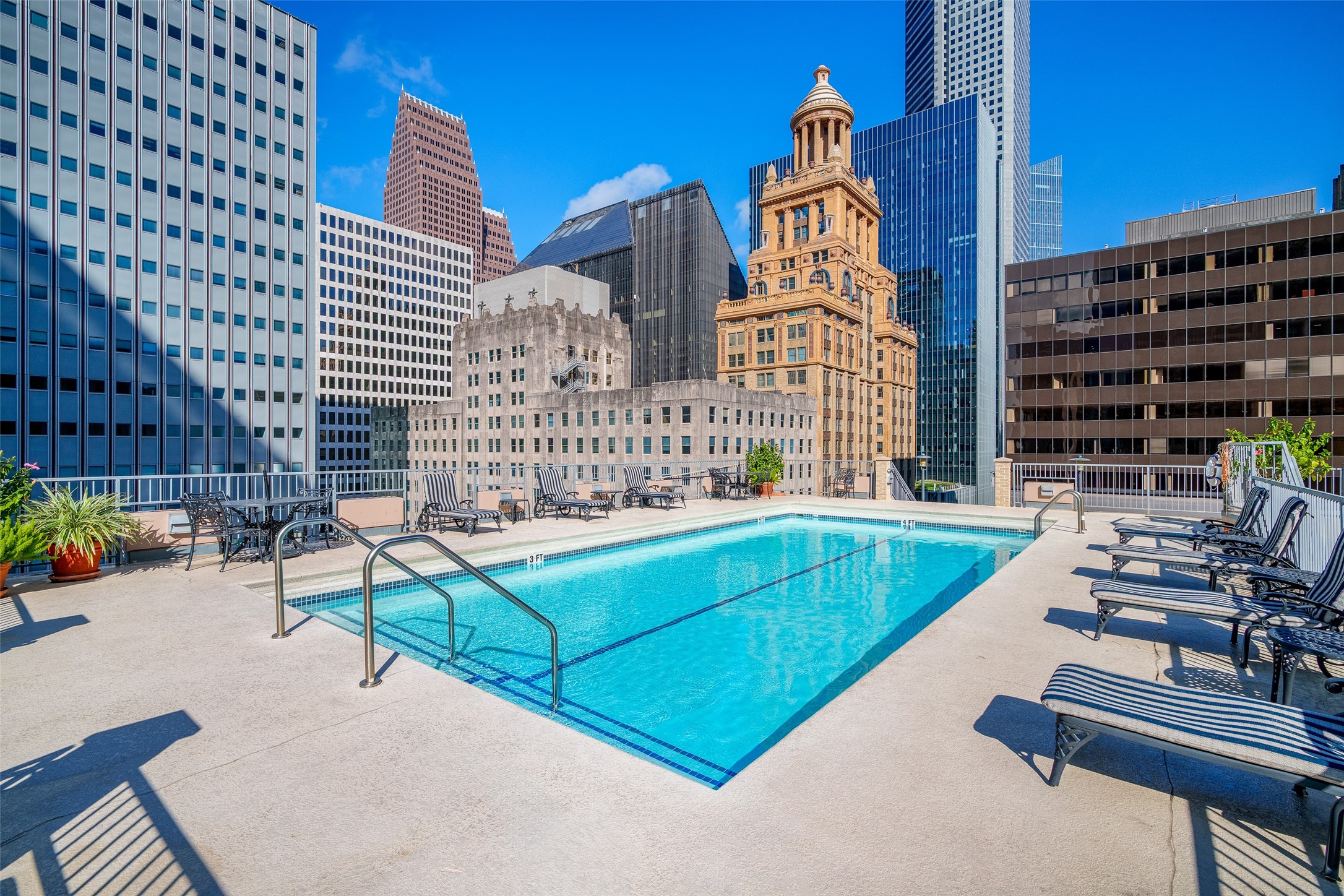 914 Main Street, Unit 1902 Houston, TX 77002 - Photo 25 of 32 a view of a balcony with two chairs and a potted plant