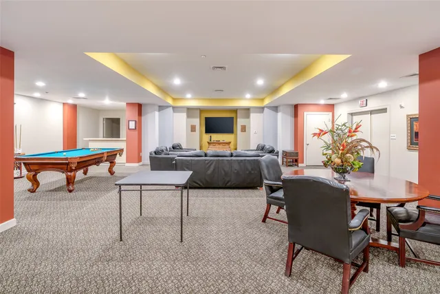 a living room with furniture kitchen view and a table