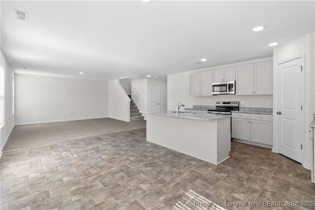 a kitchen with white cabinets and white appliances