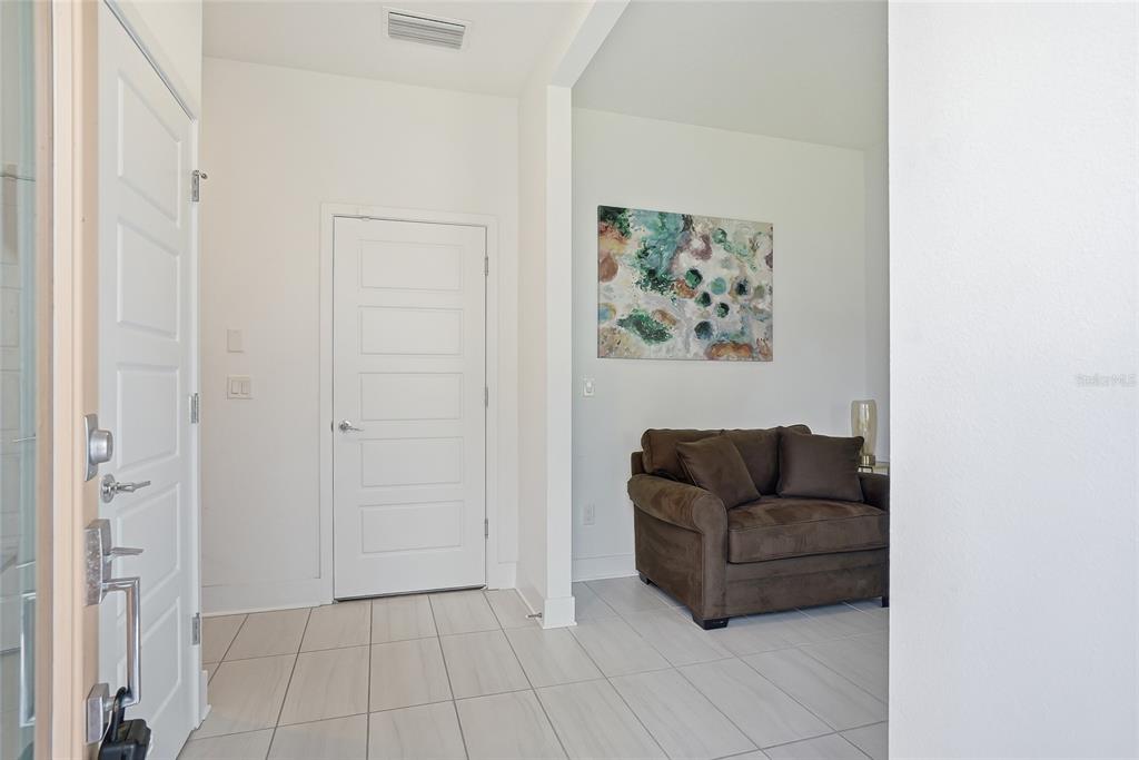 4810 West McElroy Avenue, Unit 30 Tampa, FL 33611 - Photo 7 of 43 a living room with furniture and a window