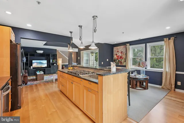a open kitchen with stainless steel appliances granite countertop a stove and refrigerator