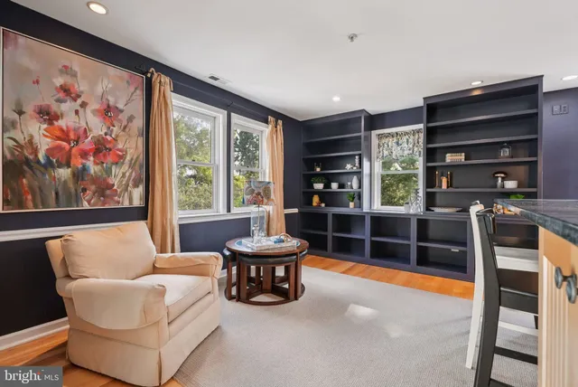 a living room with furniture a rug and a large window