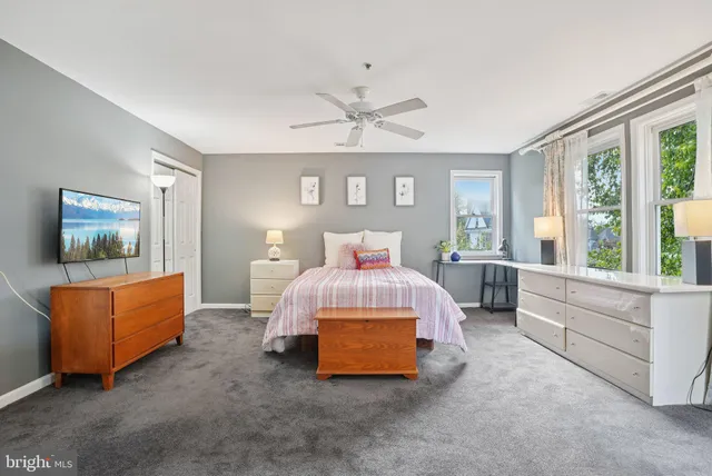 a spacious bedroom with a bed and a couch