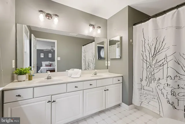 a bathroom with a double vanity sink and mirror