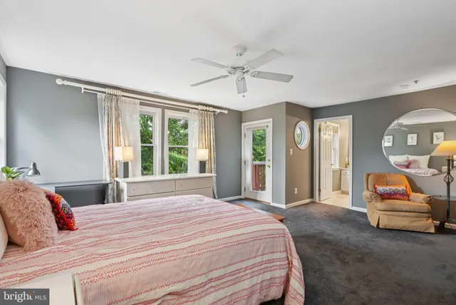 a bedroom with a bed mirror and window