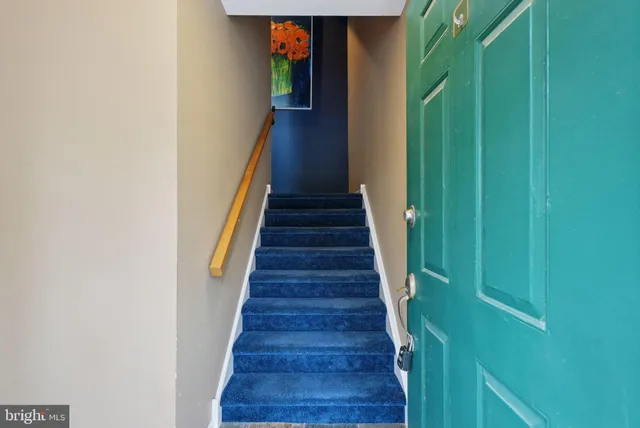 a view of staircase with white walls and a window