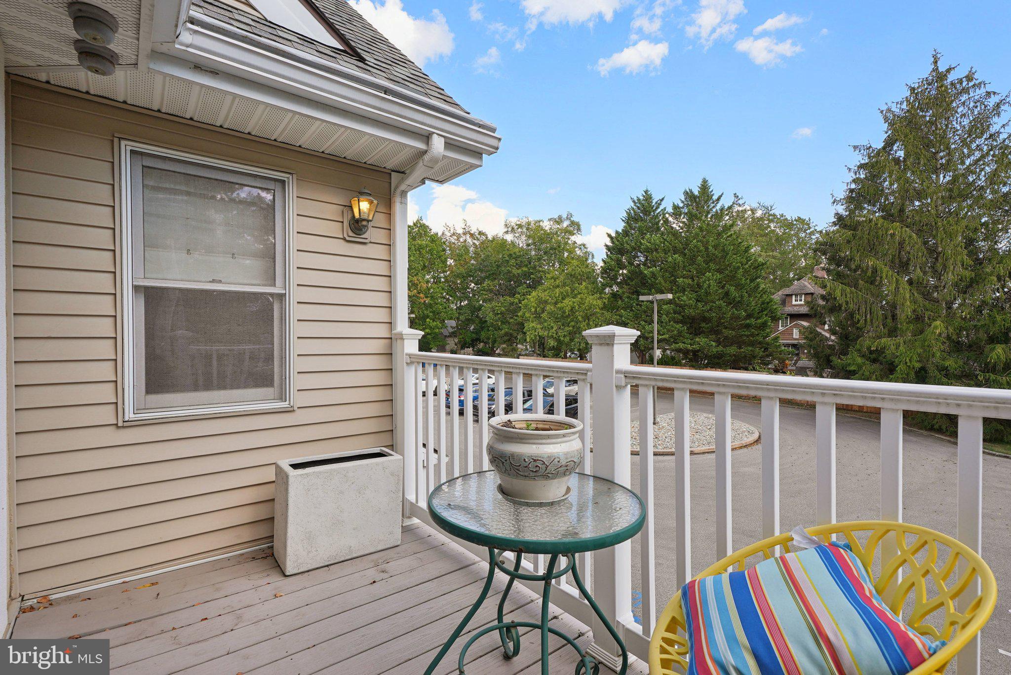 9 Comly Court Flourtown, PA 19031 - Photo 31 of 32 a balcony of a house with wooden floor outdoor seating and yard in the back