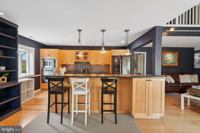 a dinning area with furniture and a large window