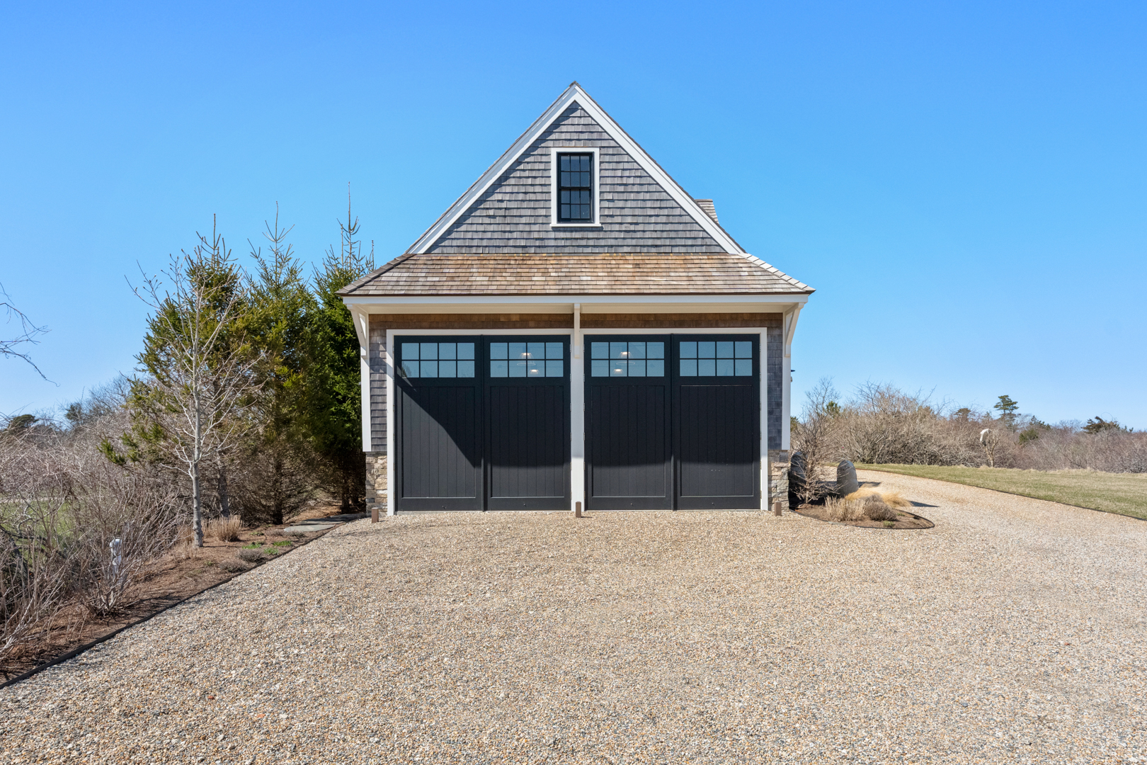 174 Cliff Road Nantucket, MA 02554 - Photo 44 of 49 a front view of a house with a yard and garage