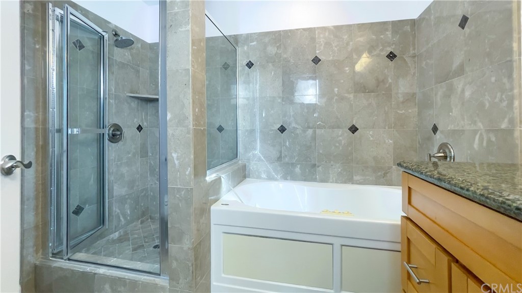 2608 Hines Drive Los Angeles, CA 90065 - Photo 18 of 38 a bathroom with a granite countertop bathtub shower sink and mirror