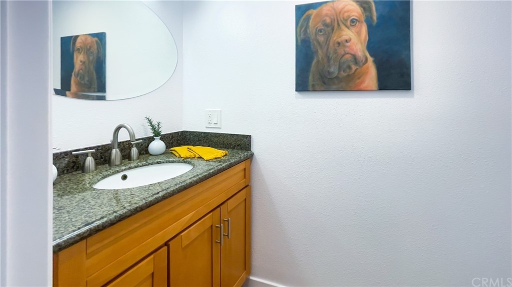 2608 Hines Drive Los Angeles, CA 90065 - Photo 26 of 38 a bathroom with a granite countertop sink and a mirror