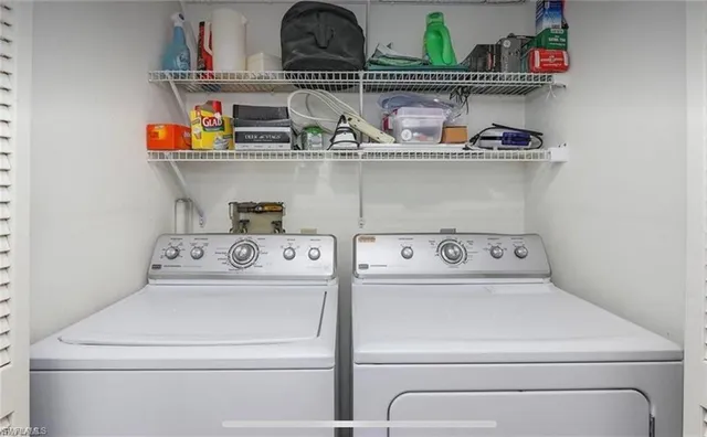 a view of storage and utility room with washer and dryer