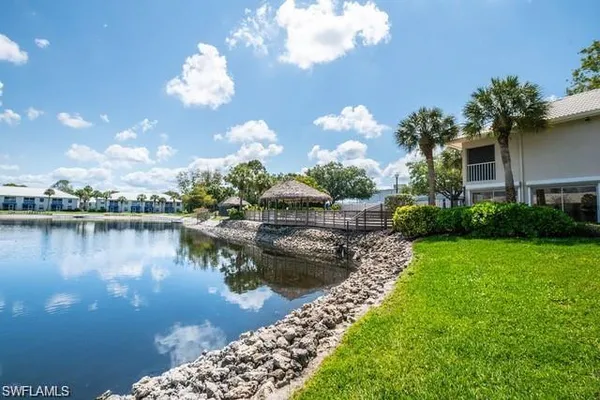 a view of a lake with a house in the background