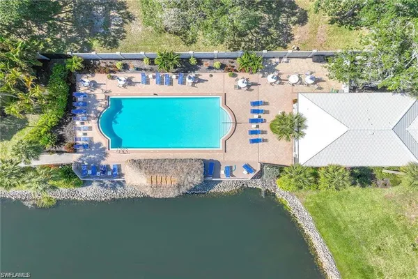 a view of a swimming pool with a lake from a balcony