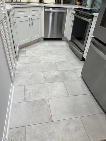 a kitchen with a stove top oven and cabinets